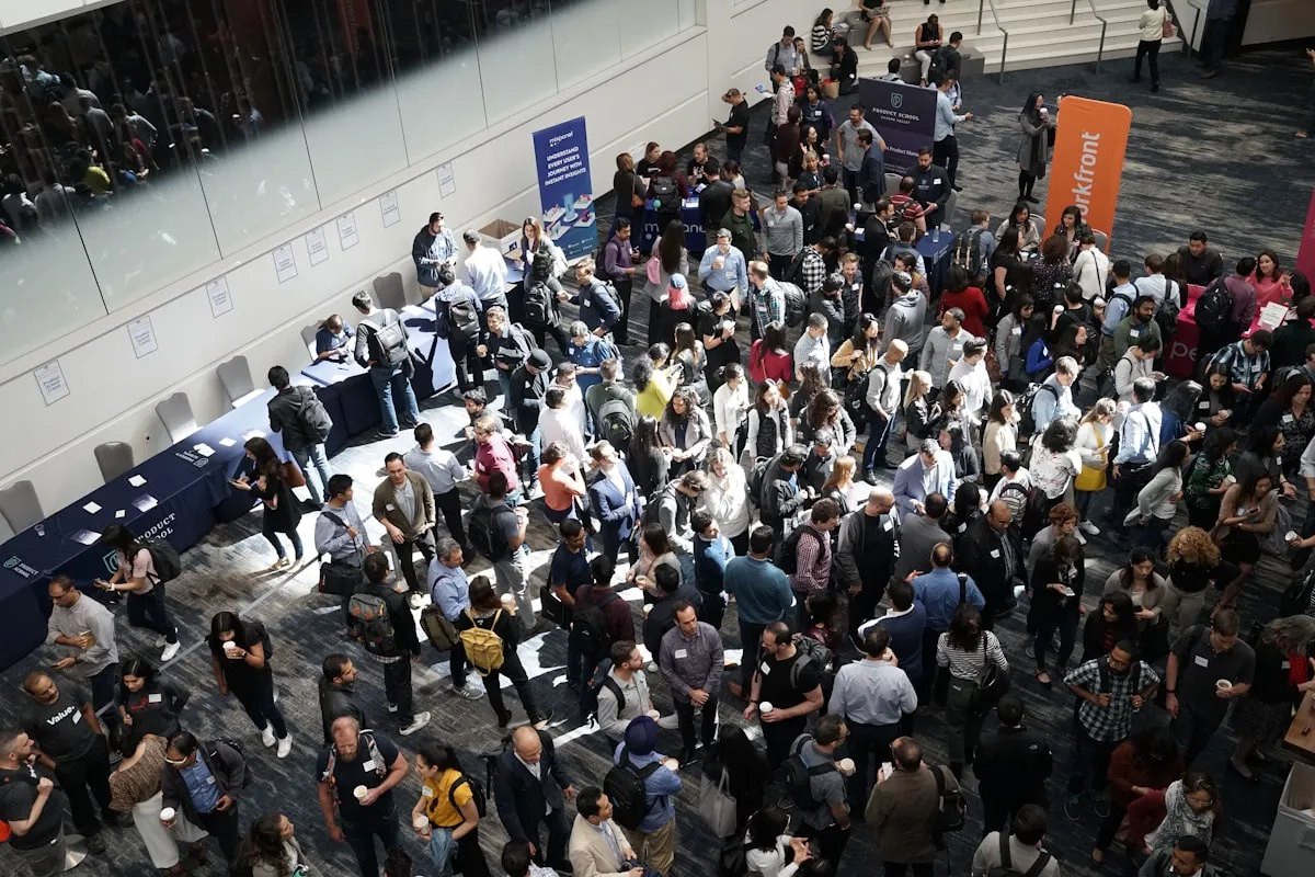 Industry professionals networking at a technology trade show exhibition with booth displays showcasing hardware products and electronic components